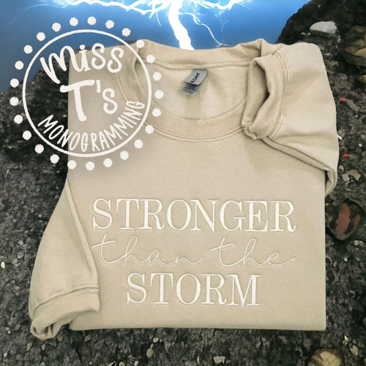 STRONGER THAN THE STORM FULLY EMBROIDERED SWEATSHIRT